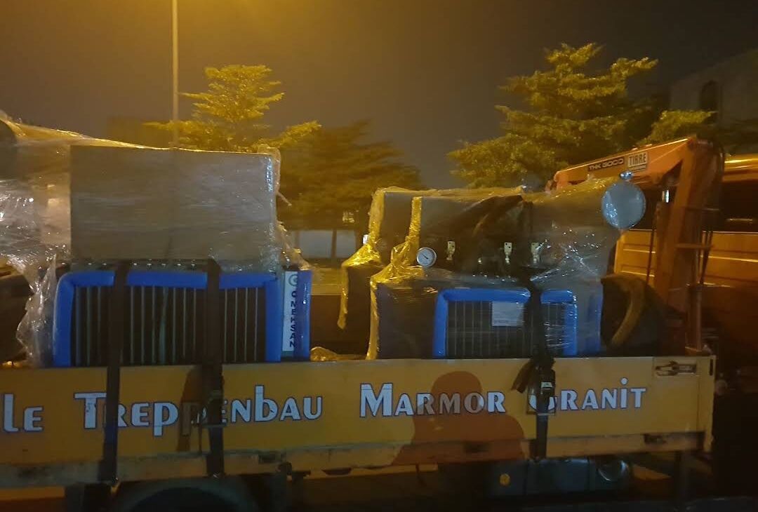 Wrapped transformers secured on a truck for delivery at night