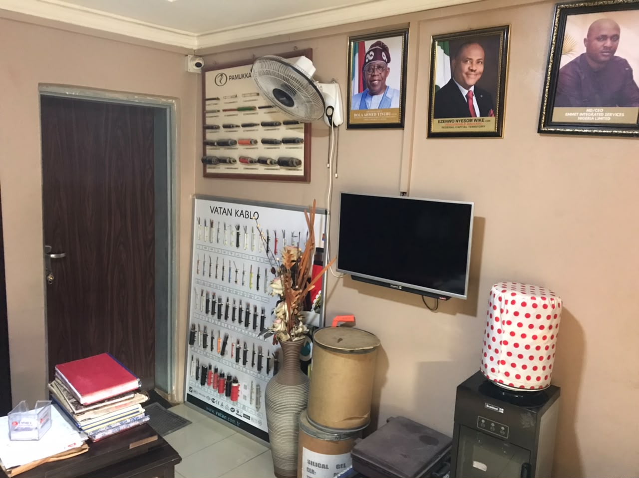 Inside the EMMET Integrated Services office in Abuja, with VATAN cable sample board on the wall