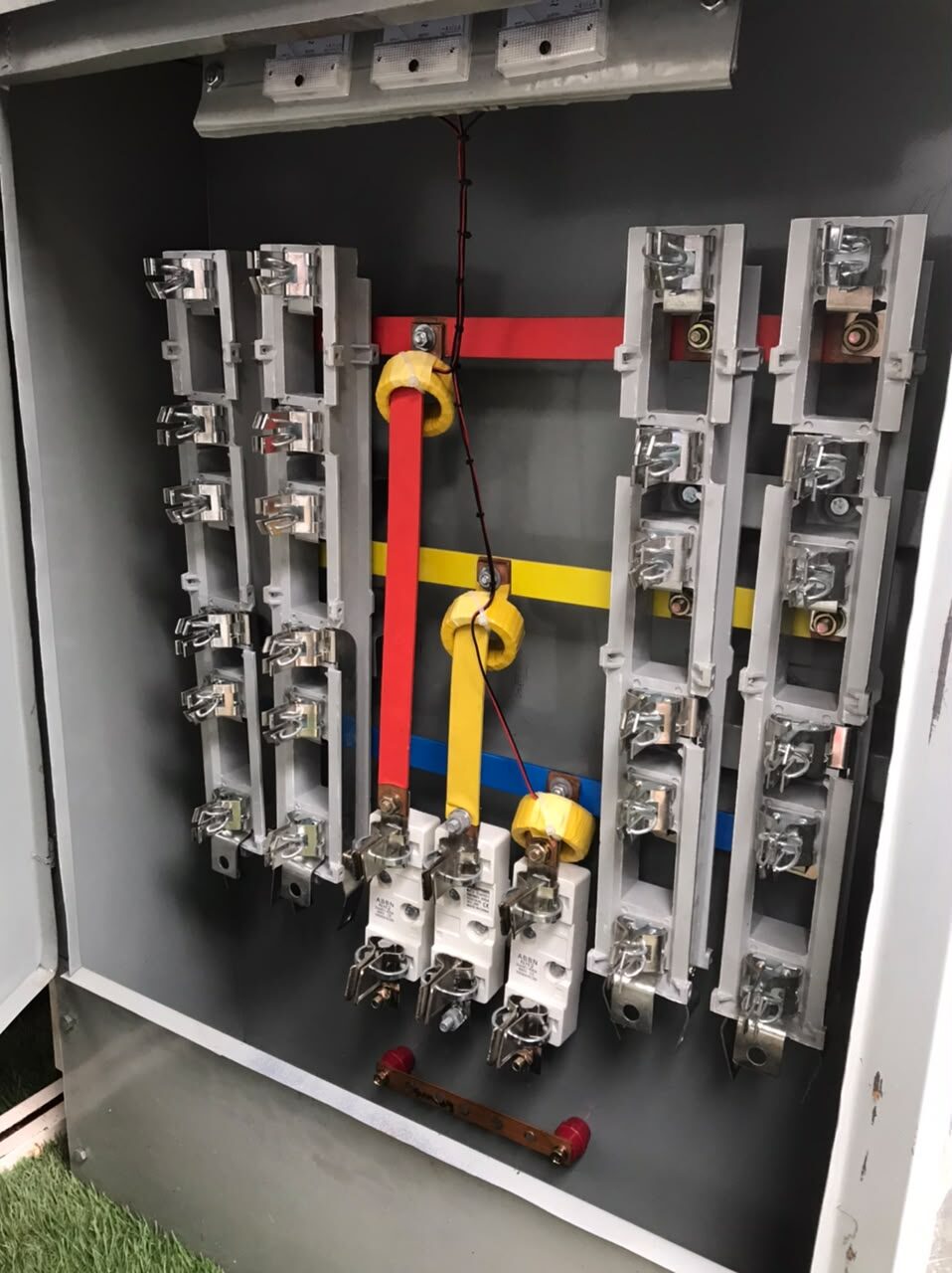 Open feeder pillar showing fuse ways and red, yellow and blue busbars